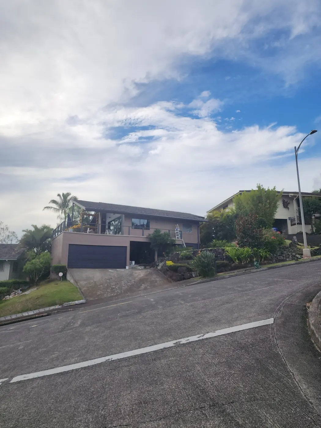 Hawaii Kai exterior: side elevation finished in turquoise, palms in the yard