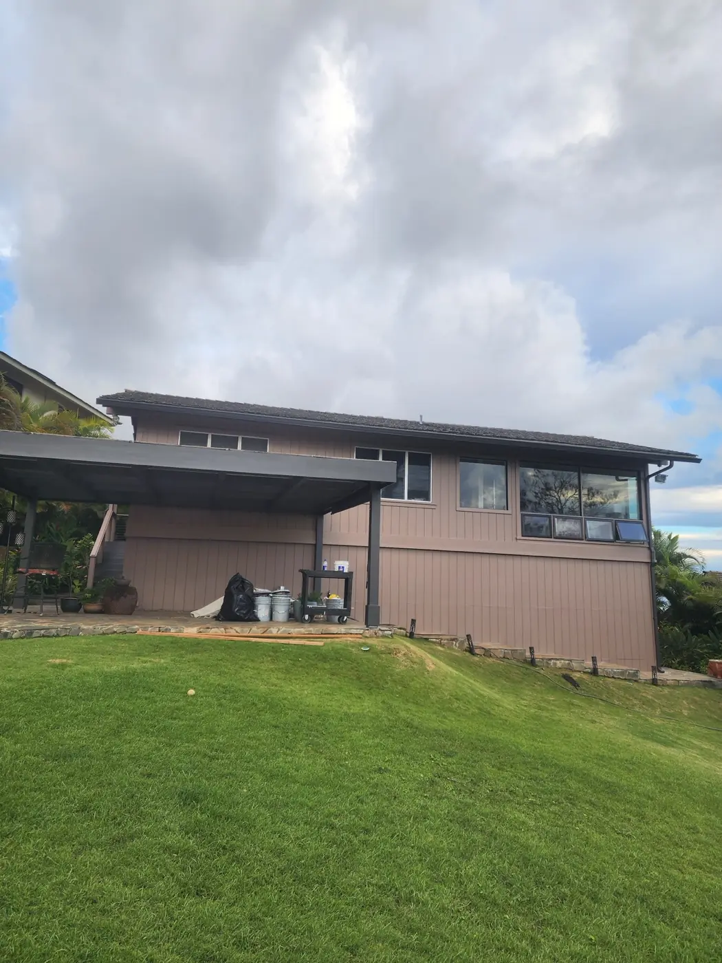 Hawaii Kai exterior: vibrant turquoise siding with crisp white trim against the sky