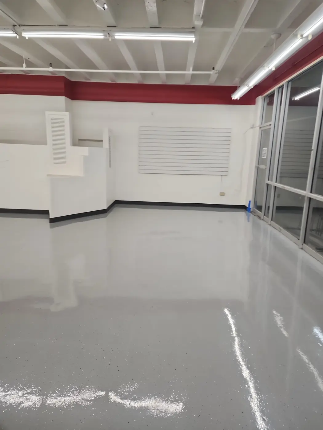 Salvation Army Kailua epoxy floor: looking down the aisle with the finished coating reflecting overhead light