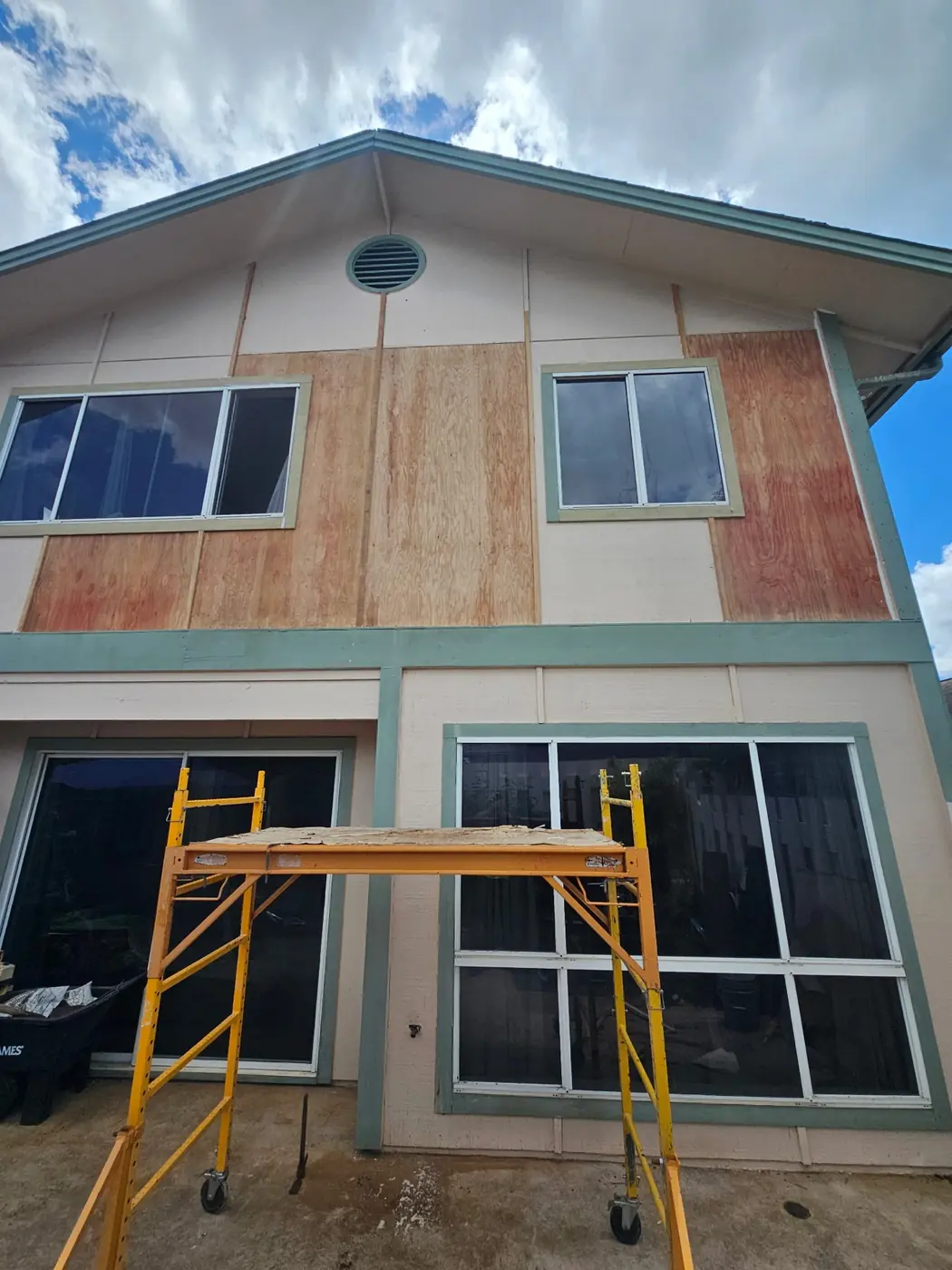 Wood-rot repair, second angle: patch tied into existing siding before primer and topcoat